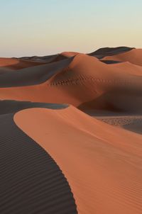 Scenic view of desert against sky during sunset