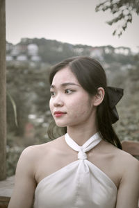 Portrait of young woman standing outdoors