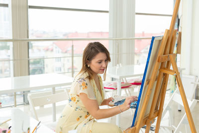 Woman painting at home