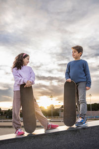 Side view of couple standing against sky