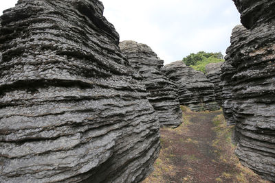 Low angle view of rock formation against sky