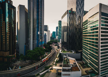 Panoramic view of city street and buildings against sky