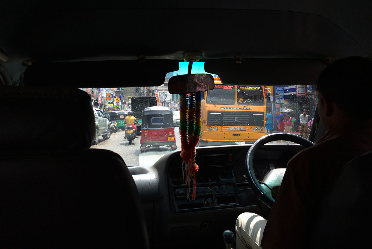 vehicle interior, transportation, rear view, car interior, real people, mode of transport, windshield, land vehicle, dashboard, two people, men, vehicle seat, sitting, indoors, day, cockpit, control panel, people