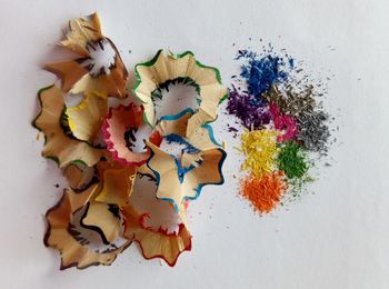 High angle view of pencil shavings on white background