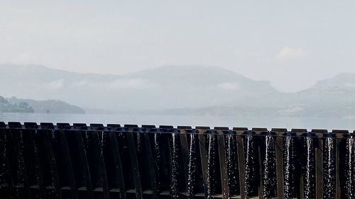 Close-up of sea against mountain range