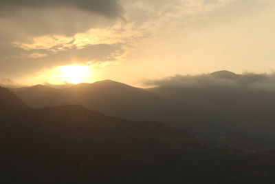 Scenic view of mountains against sky during sunset