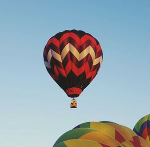 Low angle view of parachute against clear sky