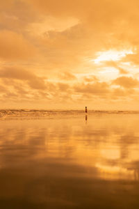 Scenic view of sea against orange sky