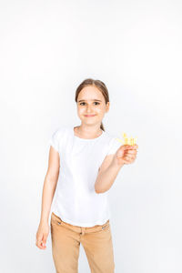 Portrait of smiling young woman standing against white background