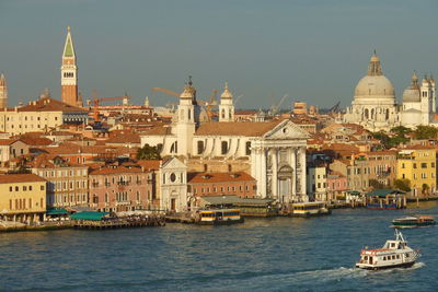 Boats in city at waterfront