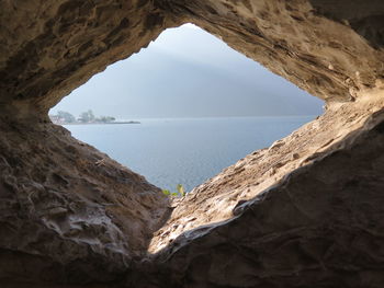 Scenic view of sea seen through arch