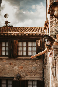 Portrait of woman against building