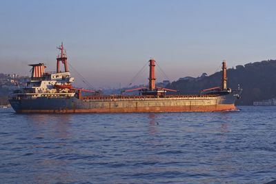 Ship on lake against clear sky