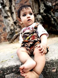 Cute boy sitting outdoors