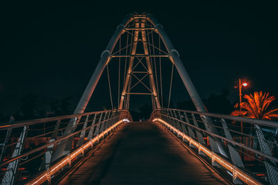 Illuminated suspension bridge at night