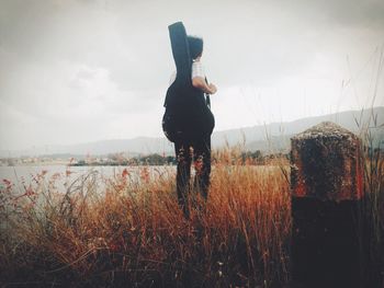 Silhouette of woman standing against sky