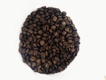 Close-up of coffee beans against white background