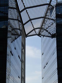 A modern glass building and its arch