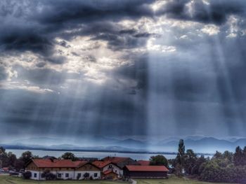 Buildings against cloudy sky