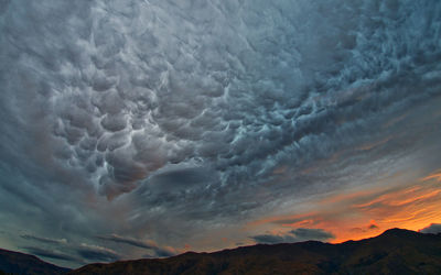 Scenic view of mountain against dramatic sky