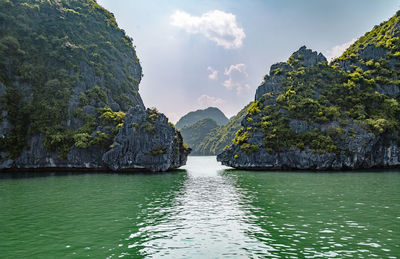 Scenic view of rocks in sea against sky