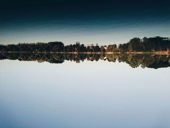 Scenic view of lake against clear blue sky