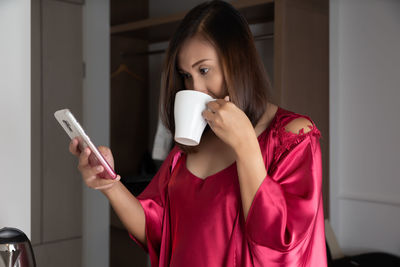 Young woman holding coffee cup