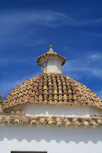 Low angle view of building roof against sky