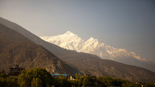 Scenic view of snowcapped mountains against clear sky