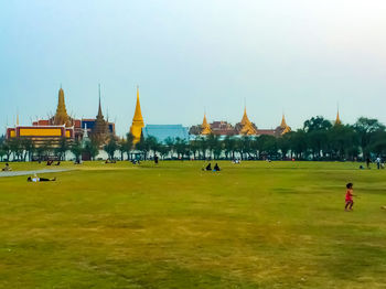 People in temple building against clear sky