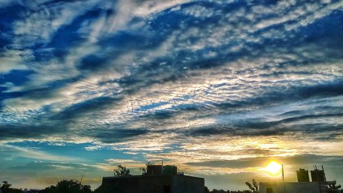 Low angle view of silhouette buildings against sky during sunset