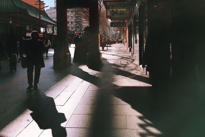 Shadow of people walking on street