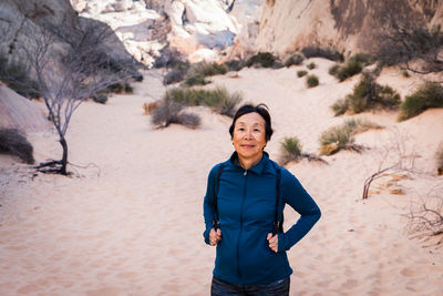 Senior asian woman hiking in the desert landscape