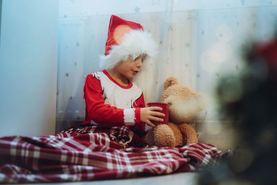 Rear view of woman with teddy bear