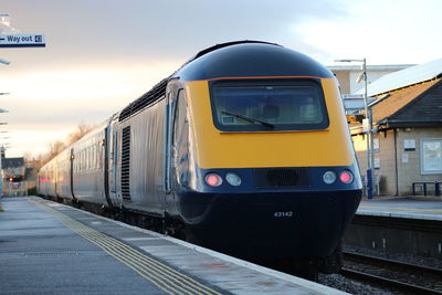 Train at railroad station against sky