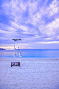 Lifeguard hut on beach against sky