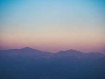 Scenic view of mountains against sky during sunset