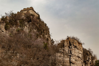 Low angle view of rock formation against sky