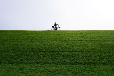 Man riding bicycle on field