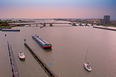 High angle view of bridge over river in city against sky