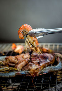 Stainless steel tongs, grilled shrimp from charcoal grill