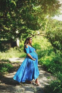 Pregnant woman standing in forest