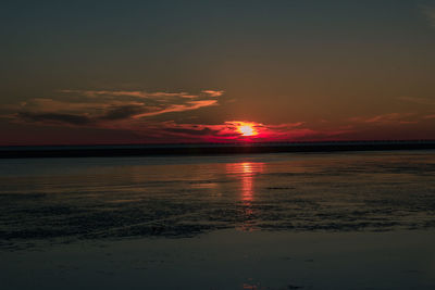 Scenic view of sea against romantic sky at sunset