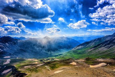 Scenic view of mountains against cloudy sky