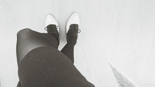 Close-up of woman standing on tiled floor