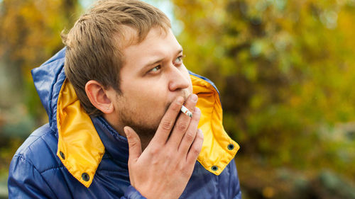 Close-up of young man smoking cigarette