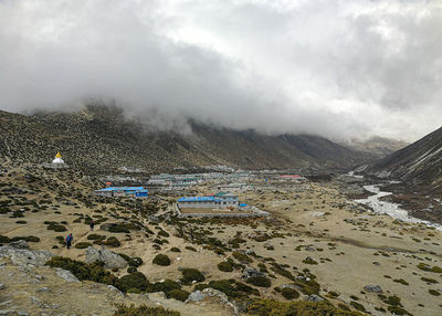 Scenic view of land and mountains against sky