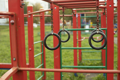 Close-up of red metal chain hanging in park