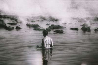 Rear view of woman in sea