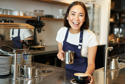 Portrait of young woman sitting in cafe